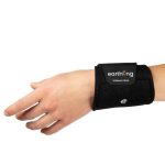 A left hand wears the Earthing Band, a black wristband featuring a metal snap button and an earthing label, displayed against a white background.