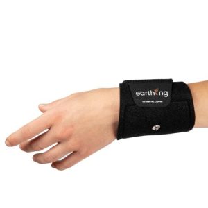 A left hand wears the Earthing Band, a black wristband featuring a metal snap button and an earthing label, displayed against a white background.