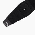 The Earthing Band is a black fabric wristband with a metal snap and a small pocket, featuring “earthing” labeled on the end tab. The product appears against a white background.