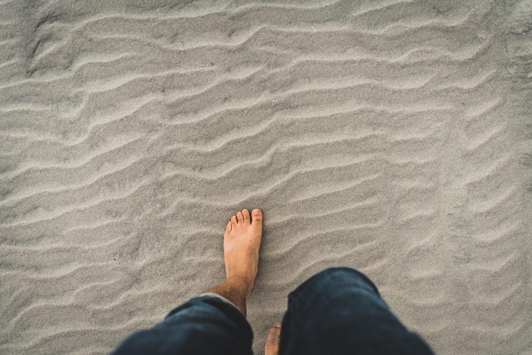 Gentleman Walking on Sand Bare Foot
