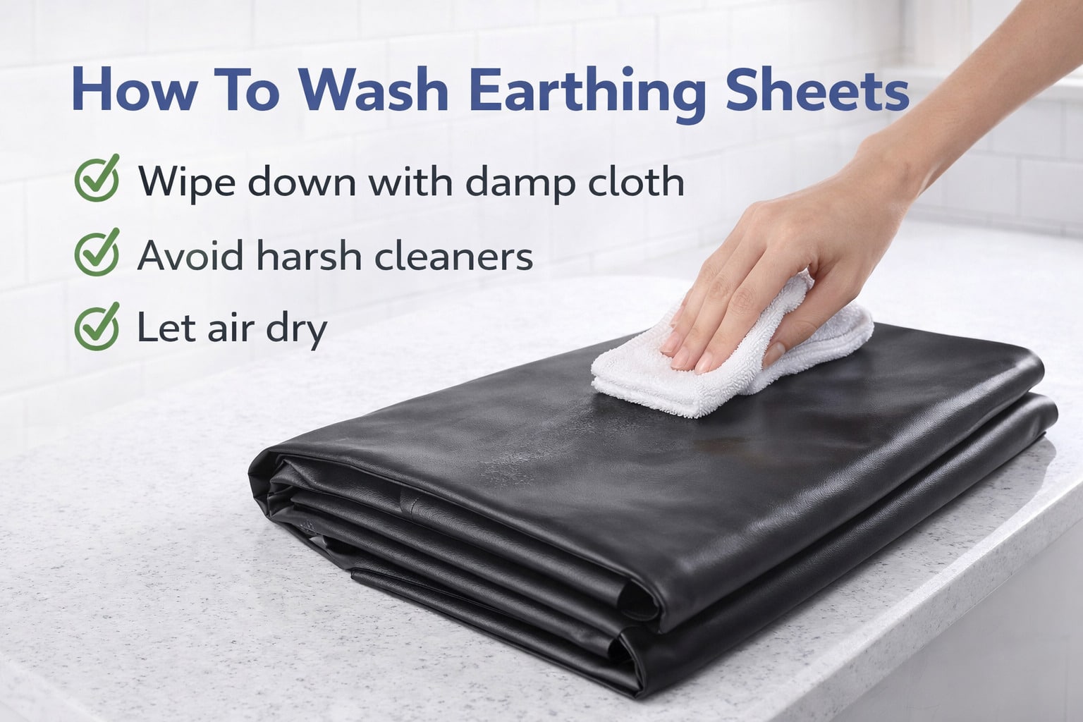 A hand wipes a folded black earthing sheet with a white cloth on a worktop. Text above reads: How To Wash Earthing Sheets & How Long Should I Ground Myself For—Wipe down gently, avoid harsh cleaners, let air dry with green tick marks.